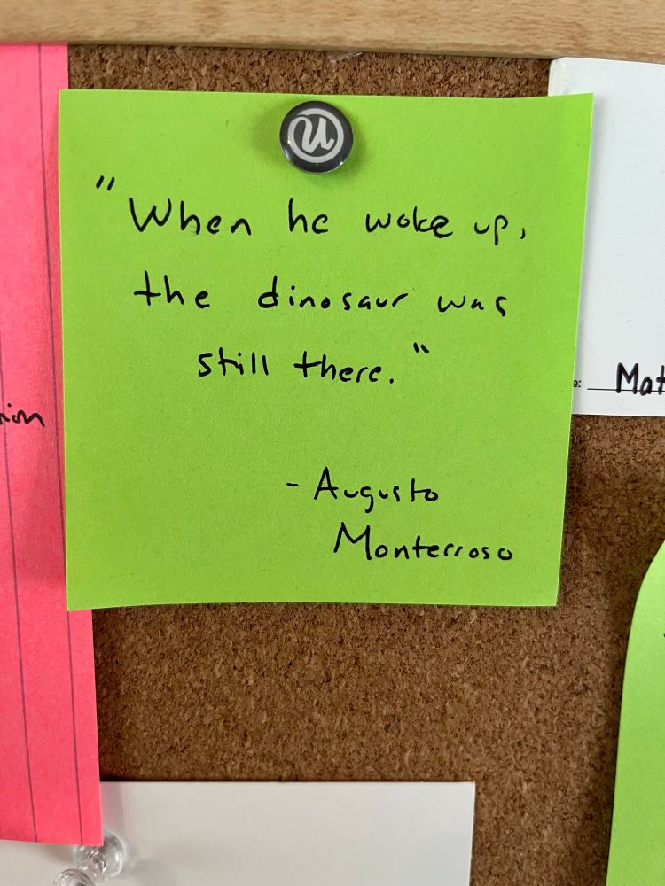 Post it note with the words “When he woke up, the dinosaur was still there, by August Monterroso”