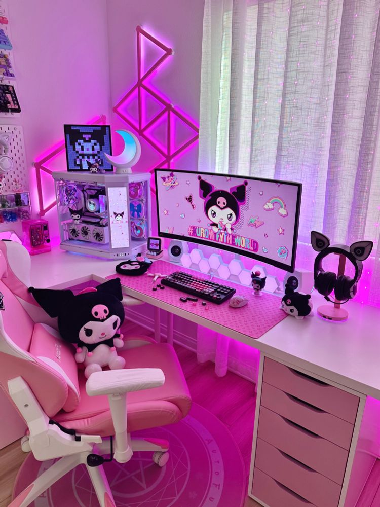 A gaming desk setup with a gaming PC and monitor, decorated with Kuromi merch, with purple and pink lighting. 