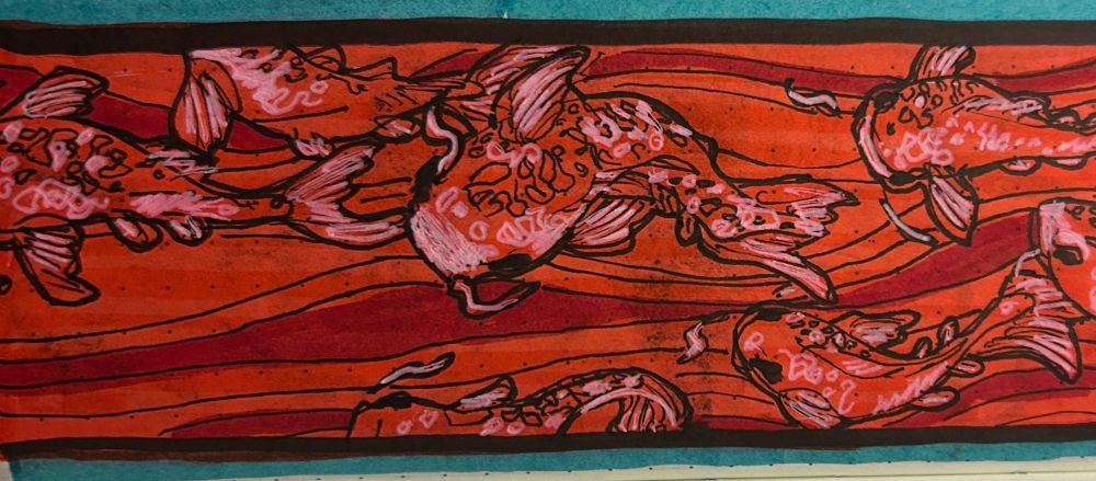 Red Koi fish swimming up stream