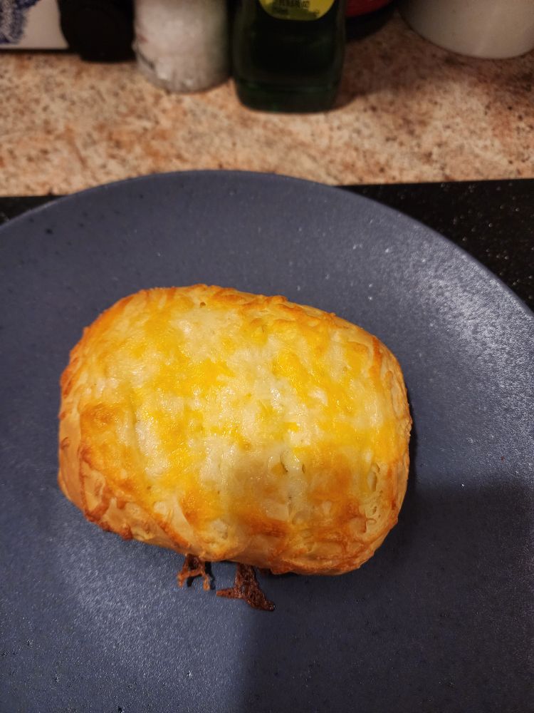 Homemade breakfast hot pocket on blue plate. 