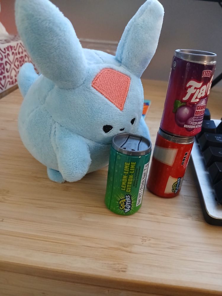 carbuncle plushie sipping from tiny soda