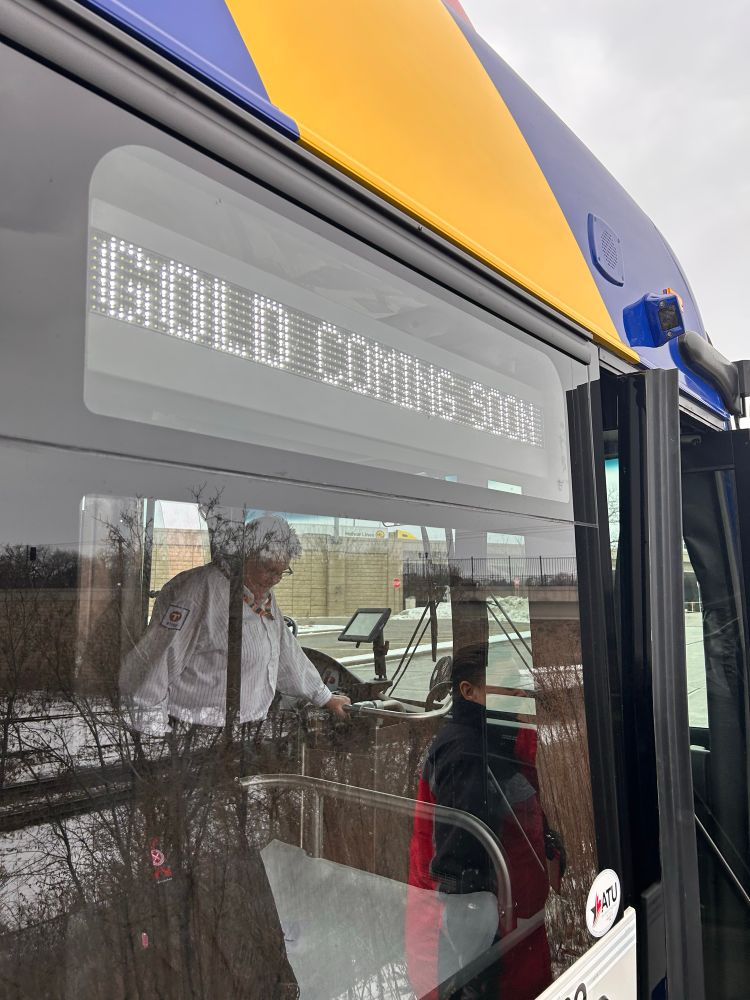 Side view of a Gold Line bus at Earl Street Station