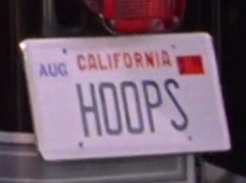 A California license plate that reads HOOPS. From Society (1989).