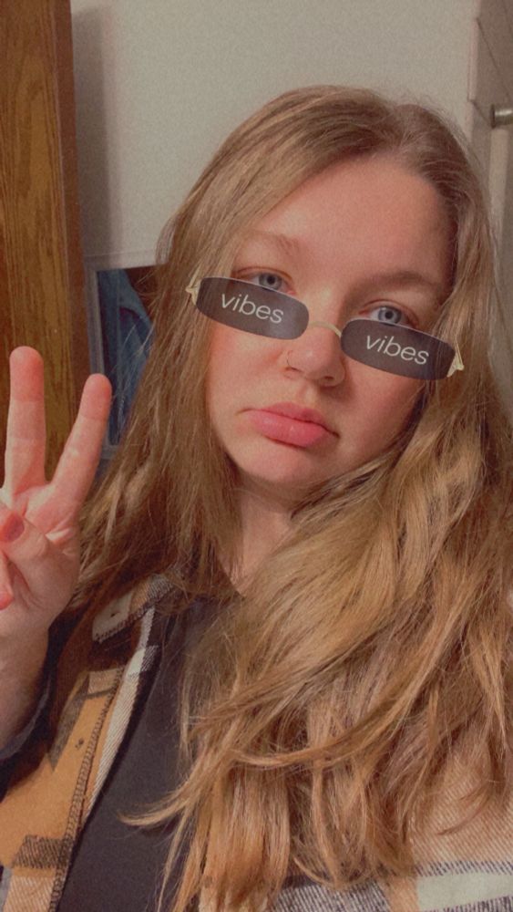 Snapchat filter with sunglasses that say “vibes.” Face that looks like it’s had enough and an ironic peace sign. 