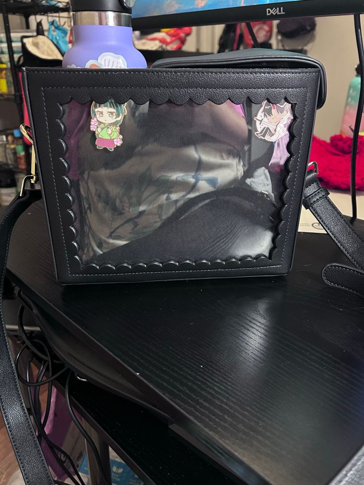 Genuine Kate Gabrielle ITA bag with a Maomao pin and KDJ pin with my reusable water bottle peaking out