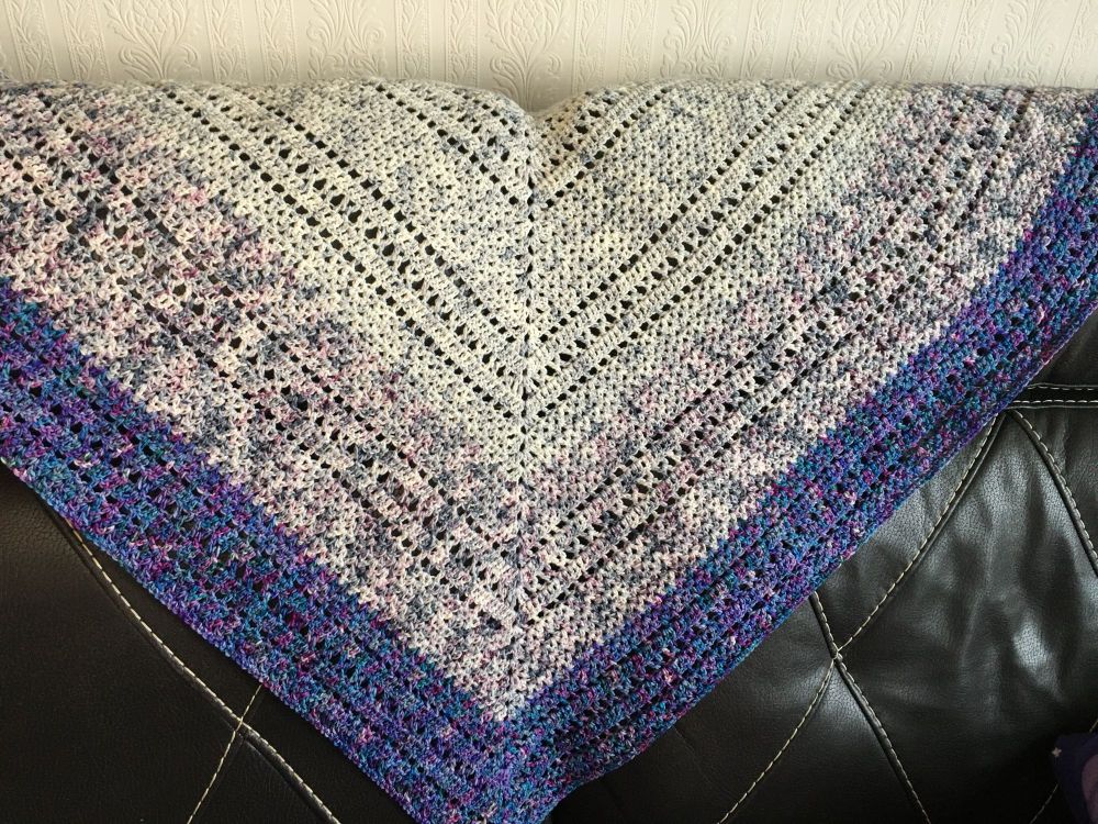 Elentári by Morben Design. A triangle shawl in shades of grey, dappled lilac and speckled dark purple. Homage to Varda Elentári. 

The yarn is hand-dyed merino, from Giddy Yarns and uses “Grey Wanderer” and “Lonely Mountain” from her Hobbit collection, and “Kings and Queens” from her Narnia collection.