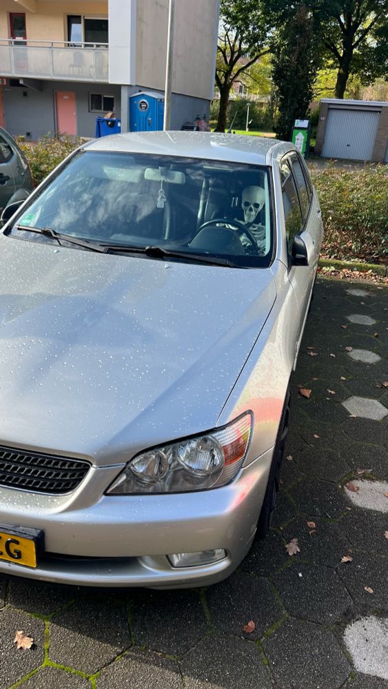 Henk the skeleton behind the wheel of a 2003 Lexus IS200 Sportcross. Hopefully he has his drivers license…