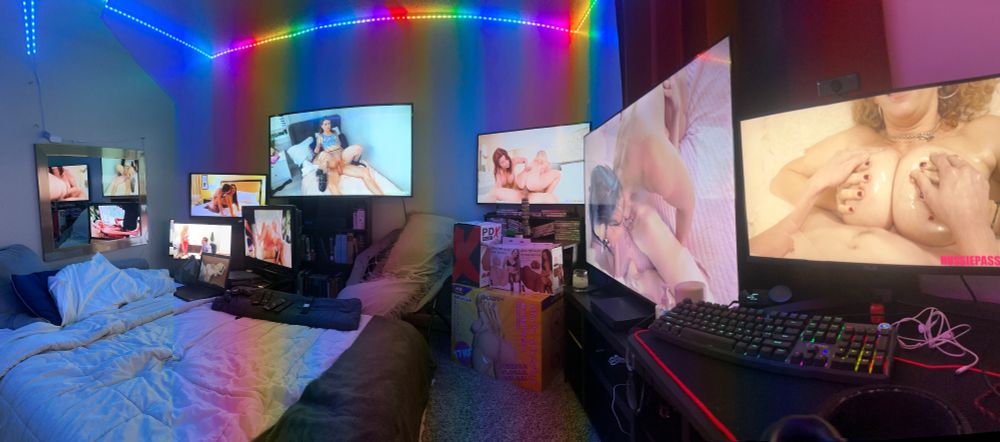panorama of bedroom with rainbow lights and multiple monitors playing porn