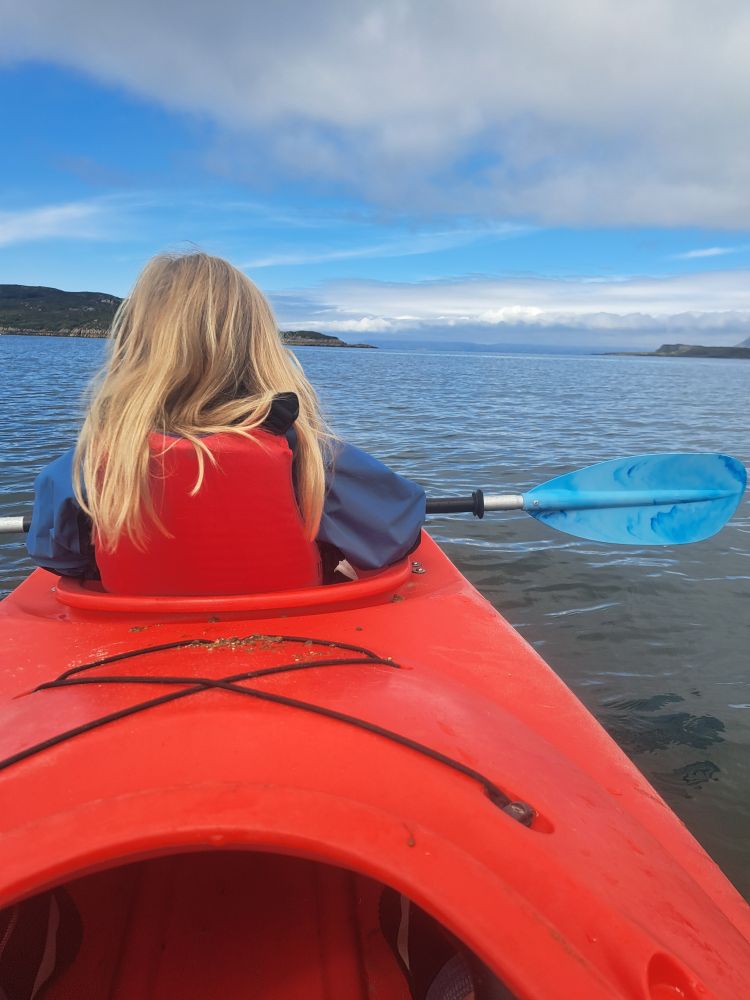 The back of my younger daughter's head as she sits in front of me in a kayak 