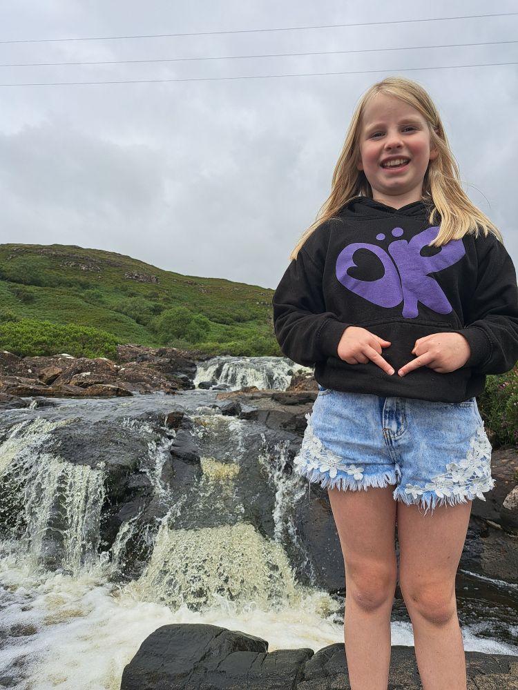 My younger daughter standing in front of a waterfall. She is also very subtly showing you the middle finger 