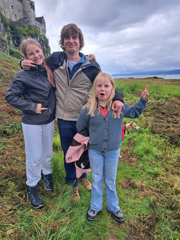 Me and my daughters standing below Duart castle. Teddy the whippet is behind us. There is a subtle hidden message (we're giving you the middle finger)