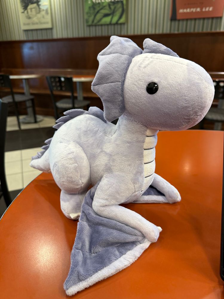 Stuffed animal toy - a purple wyvern. 