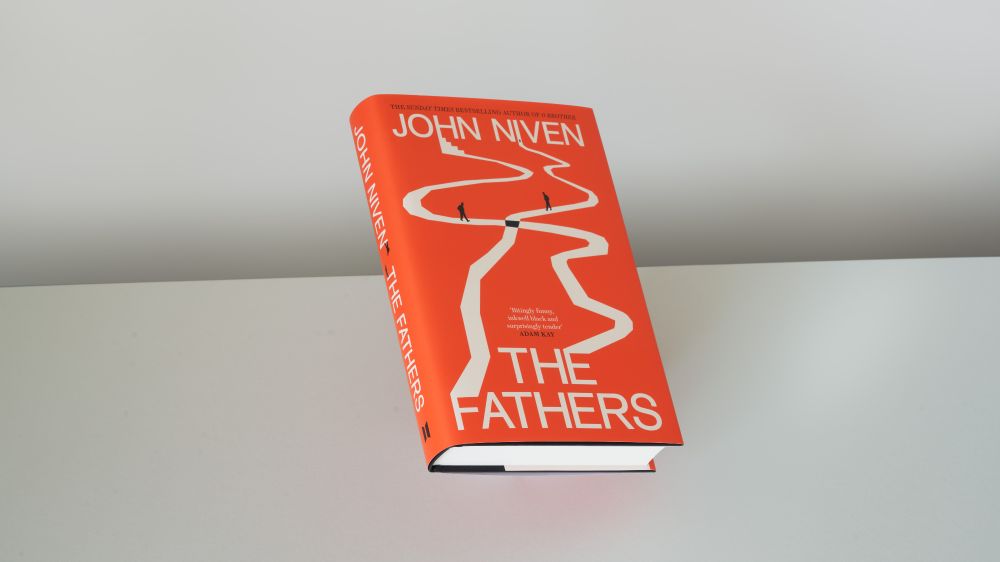 A hardback copy of The Fathers by John Niven floating against a grey background