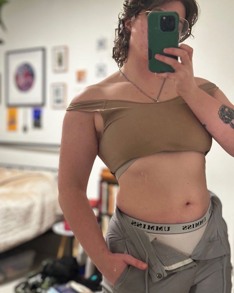 Mirror selfie of Lex, a white transmascine person