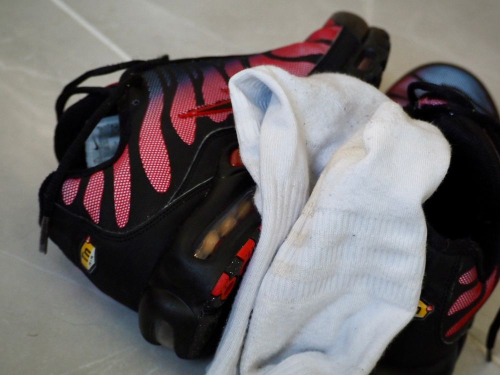 Red and black Nike TNs and sweaty white socks