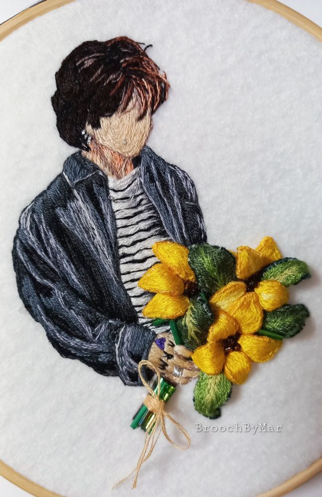 Embroidery of Jungkook of BTS in his MV, seven. He is holding a bouquet of Sunflowers 