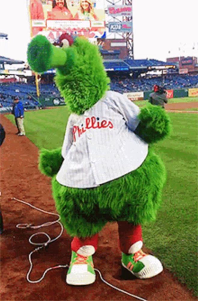 a phillies mascot is standing on the field