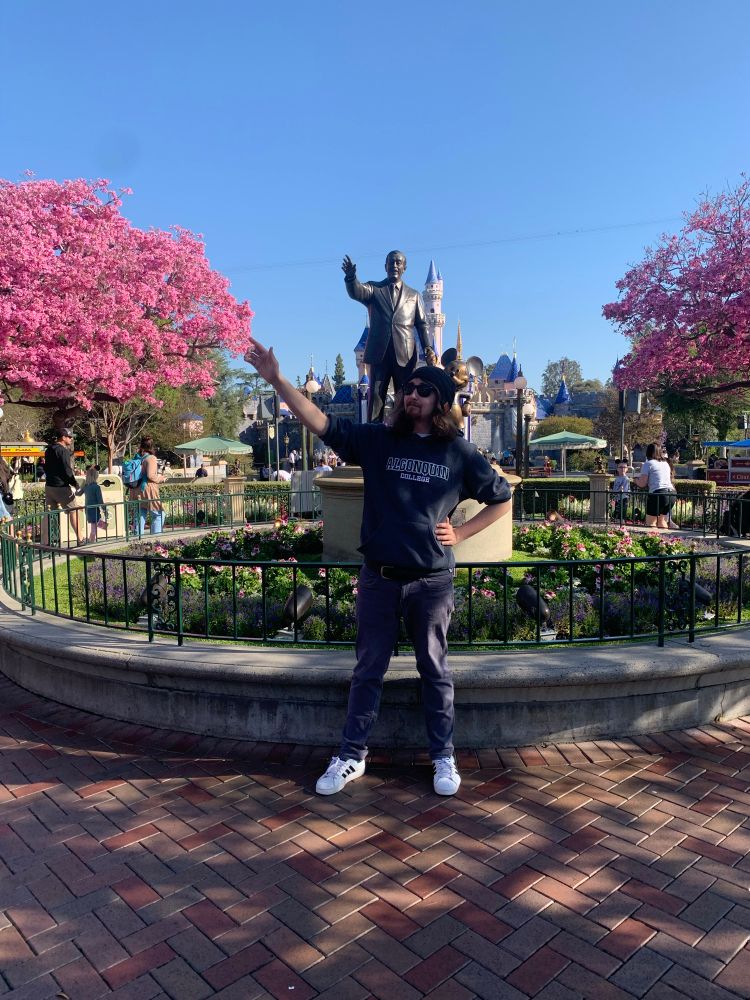 Me posing in front of the Partners statue in Disneyland Park
