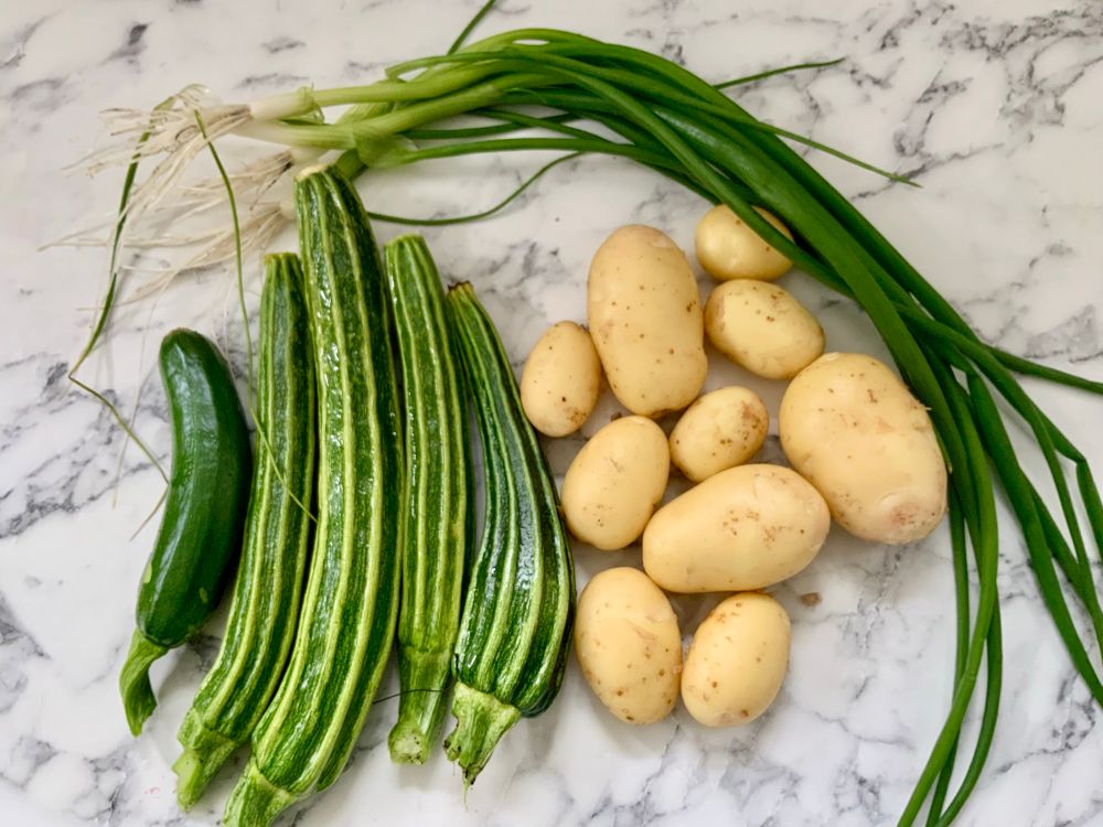 Stripes courgettes, new potatoes, and spring onions.