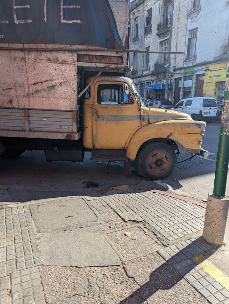 A very old truck parked near the feria. 