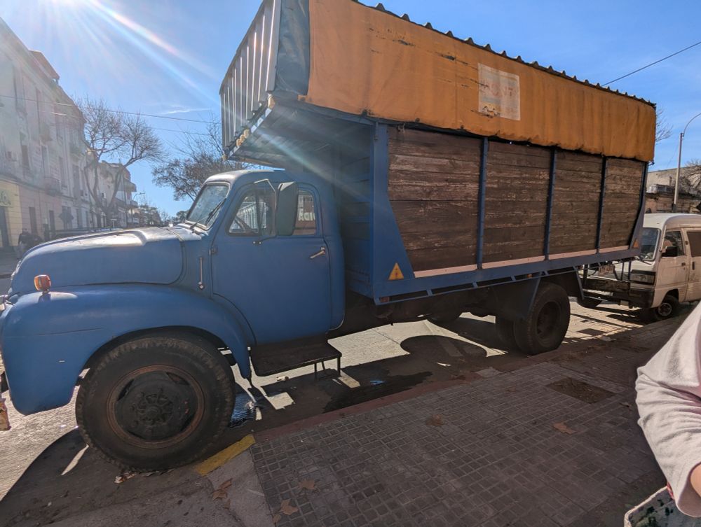 A very old truck parked near the feria. 
