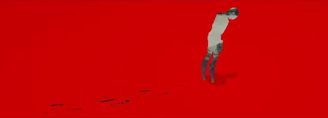 a person in a white shirt is standing on a red surface ..