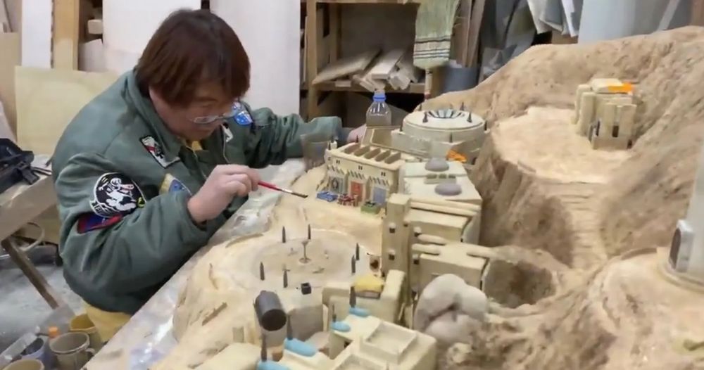 Photo of an artist creating a diorama for use of the backgrounds of Fantasian