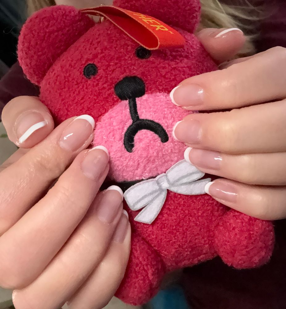 French tip manicure holding earthbound teddy bear plush