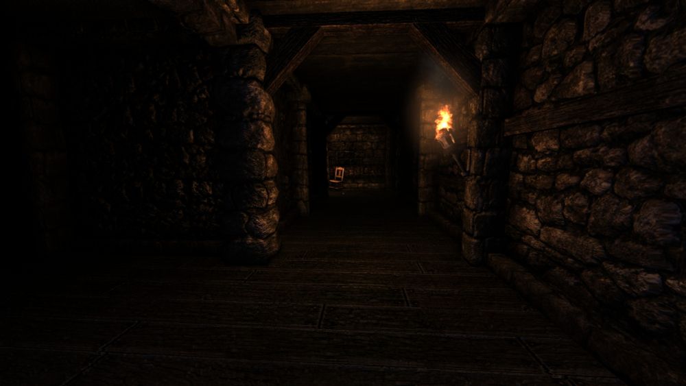 Screenshot from Amnesia: The Dark Descent: A dark room made of cobblestone and wood, lit by an old torch with a chair in another room.