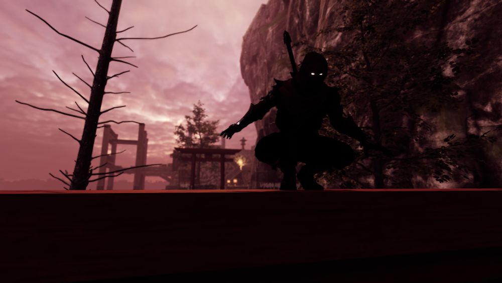 The illusive Aragami, a ninja made of shadows. Stands atop a Torii gate with another Torii gate and a couple trees in the background.