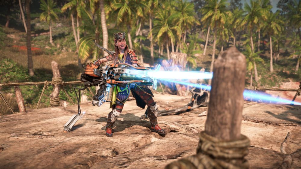 Aloy happily firing a heavy weapon.