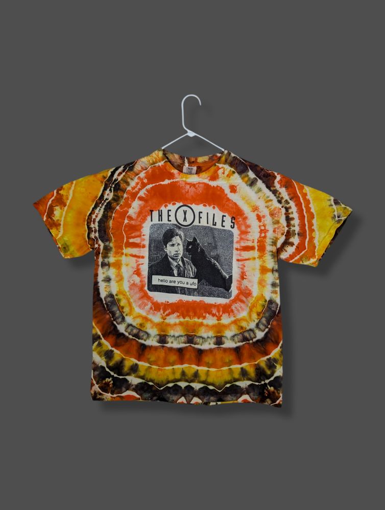 An X-Files t-shirt featuring Mulder asking a cat (or a cat asking Mulder?) the question "are you a UFO?"

I left some blank space around the graphic and dyed the rest of the shirt brown, orange, and yellow in the geode ice-dye style of tie-dye.