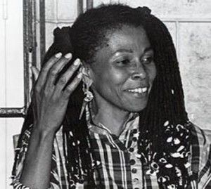 Assata gesturing and smiling