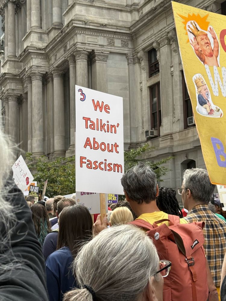 A sign reading “we talkin’ about fascism”