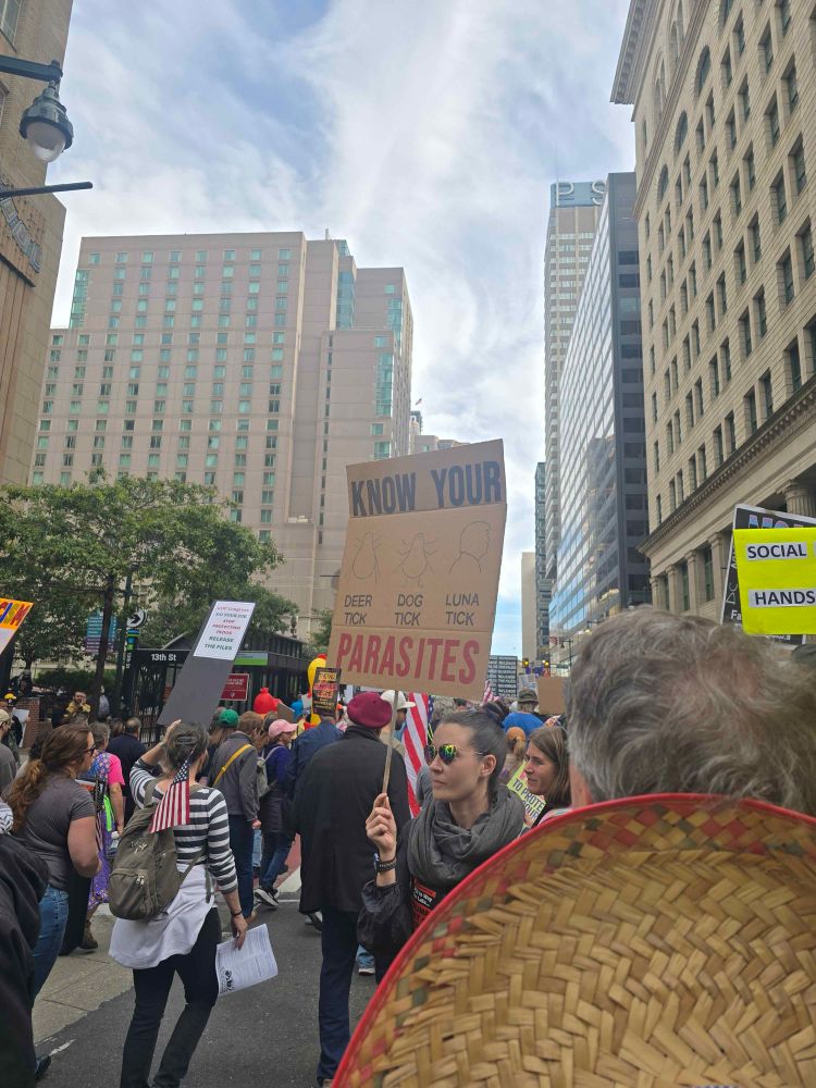 A sign reading “Know your parasites - deer tick, dog tick, luna tick”