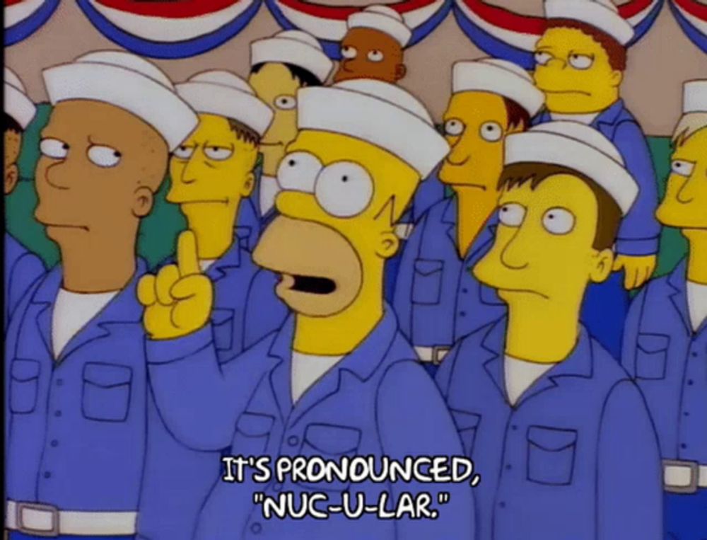 homer simpson is standing in a crowd of sailors and says it 's pronounced nuc-u-lar