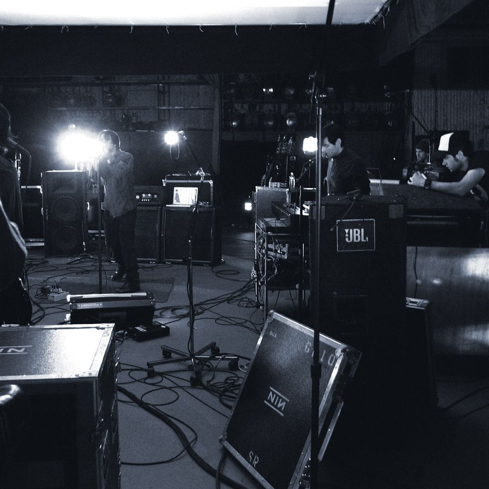 Nine Inch Nails performing in a rehearsal space surrounded by gear, with me filming, for "The Hand That Feeds" music video, Los Angeles, March 2005.