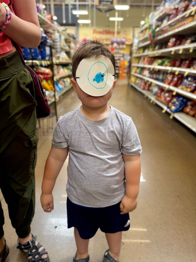 It is Mike Wazowski, a cyclops we met at the store. It is definitely not our son iO wearing a circle of paper on his face with an eyeball drawn on it.