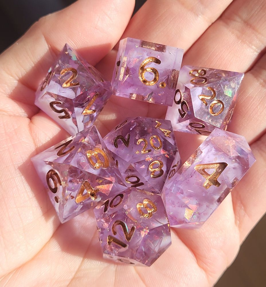 7 piece handmade polyhedral dice set, done in a light purple colour with reflective flakes & a swirl of white ink