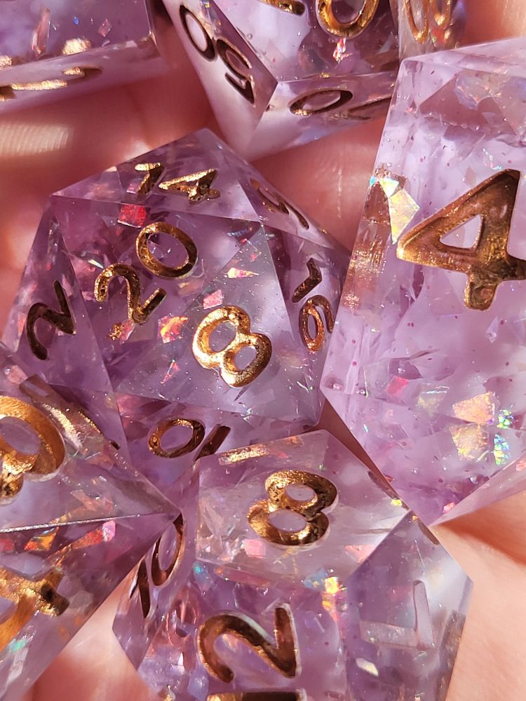 Close-up photo of some reflective details within a light purple polyhedral dice set