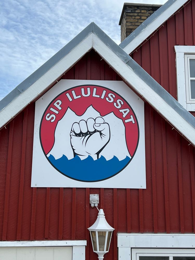 Logo for a labor union showing a fist rising into an iceberg from the sea