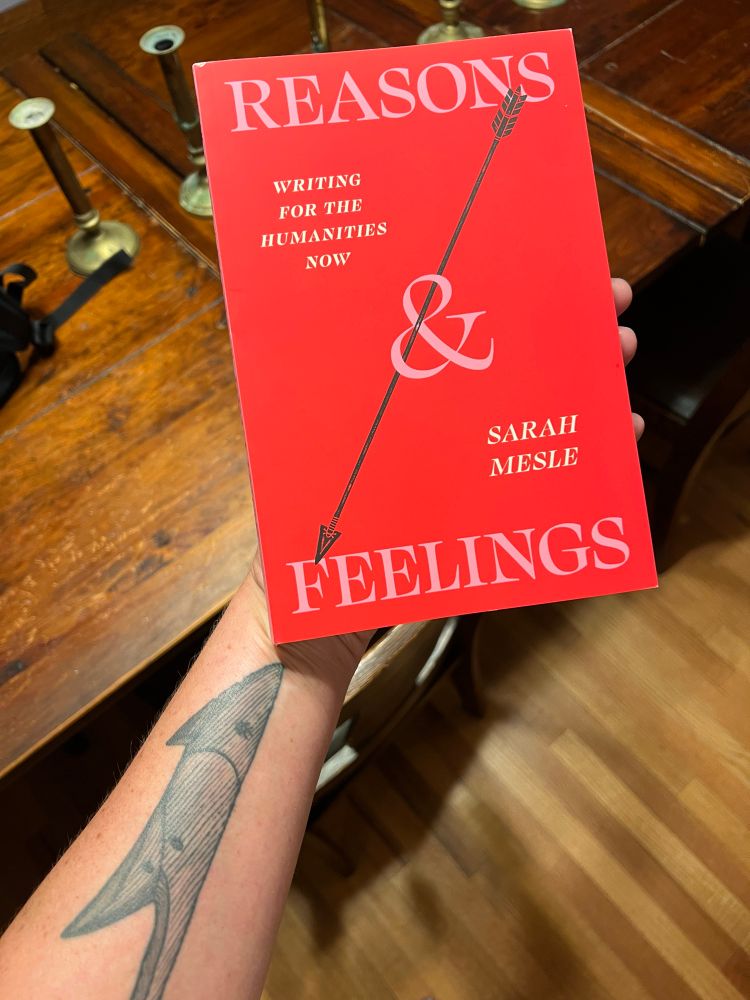 Sarah Mesle’s brilliant new book Reasons & Feelings: writing for the humanities now, with a bright red-pink cover featuring a tattoo-style arrow, saying hello to my tattoo of a Temple toggle harpoon head