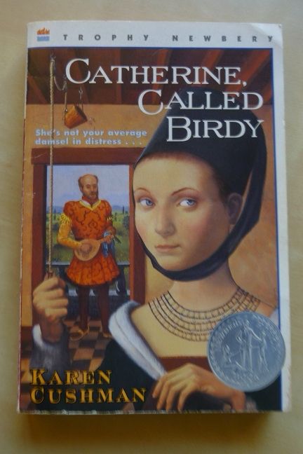Illustration of an impertinent-looking medieval teen girl on a book cover. “Catherine, Called Birdie,” by Karen Cushman.