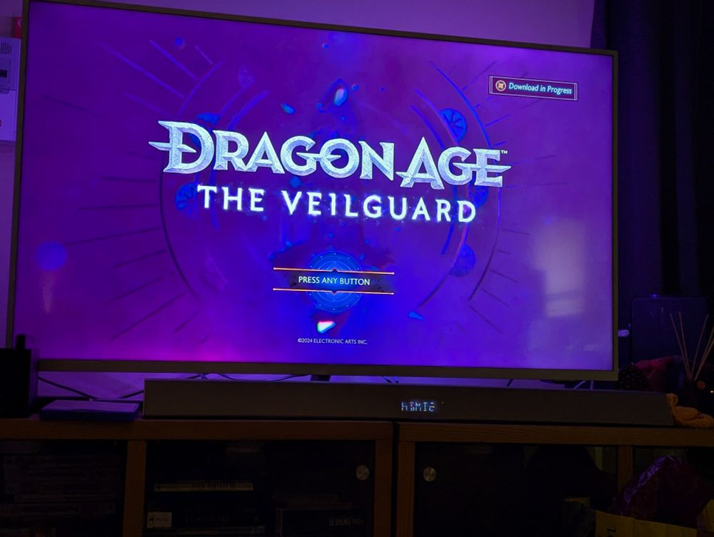Terrible photo of a TV showing the Dragon Age Veilguard start screen