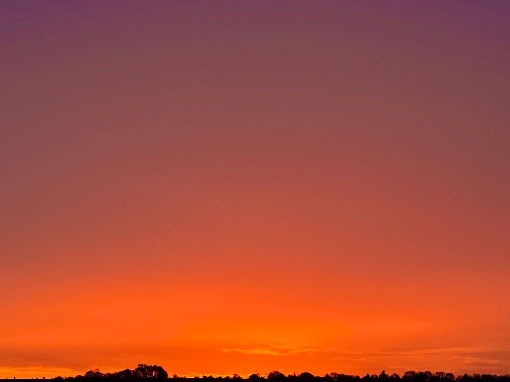 A red sky over a thin black horizon 