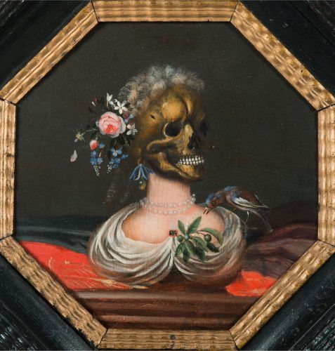 A painted bust of a woman whose head is a skull, adorned by flowers and a bird pecking at a branch