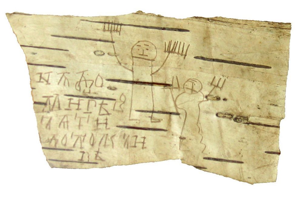 Child's drawings and Cyrillic letters scrawled on birch