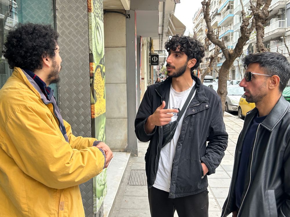 Two reporters interview a man