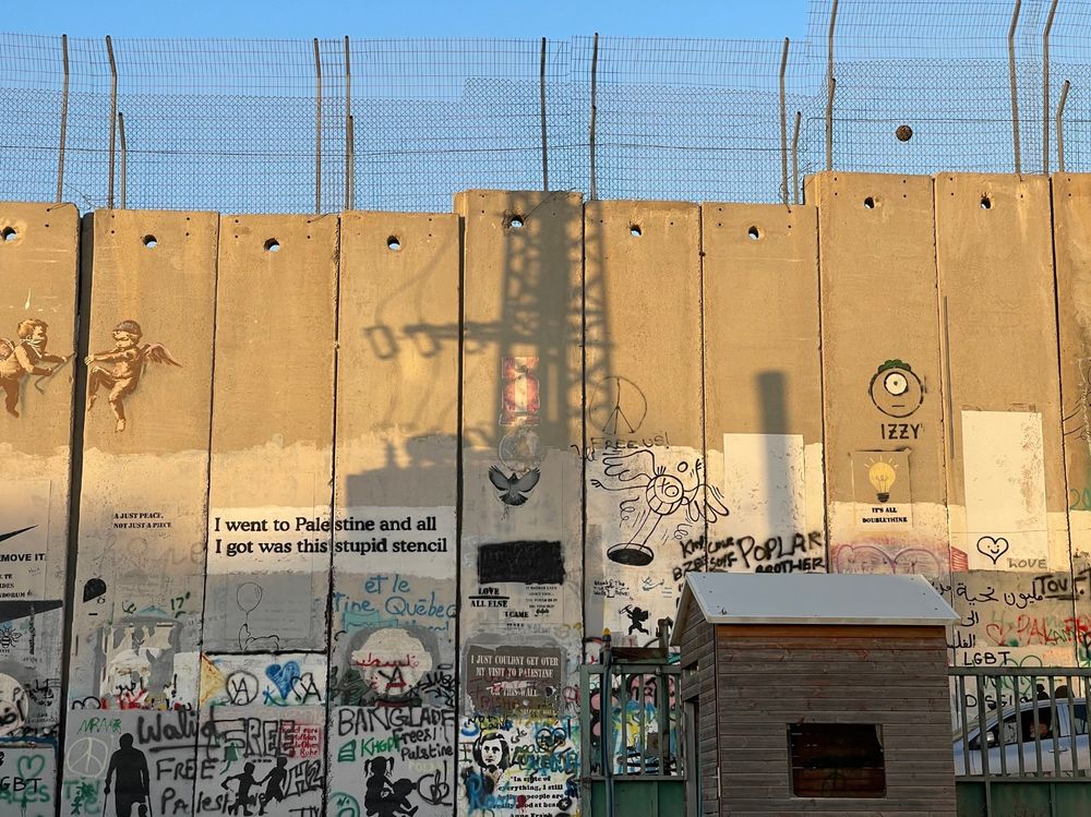 The wall in Bethlehem, West Bank at sunset, with shadow of surveillance tower. Credit: Florian Schmitz