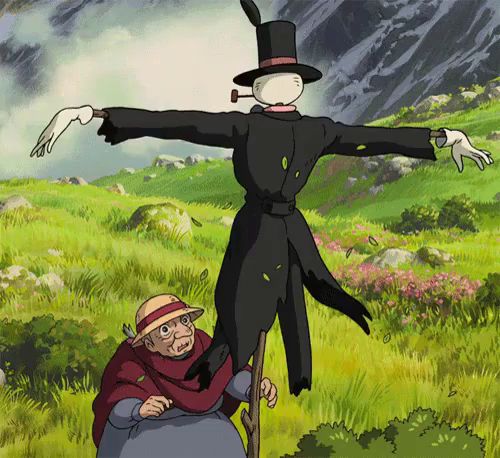 a scarecrow with a top hat is standing next to an old woman